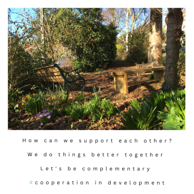 Two benches face each other in a small public space in Bristol
